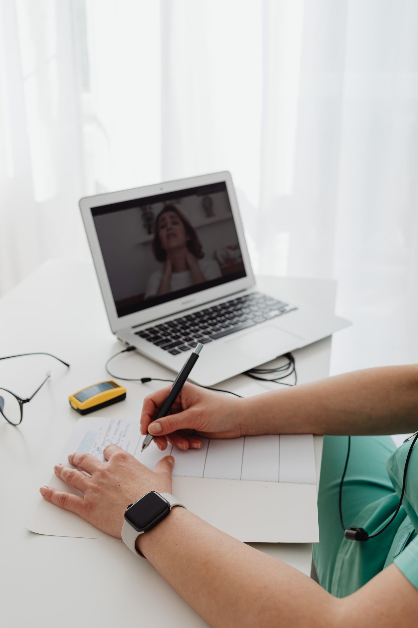 Coach maakt notities tijdens een online sessie bij het digitaliseren van haar coachtraject